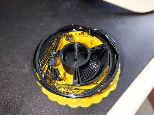 a photograph of a very stringy 3d print